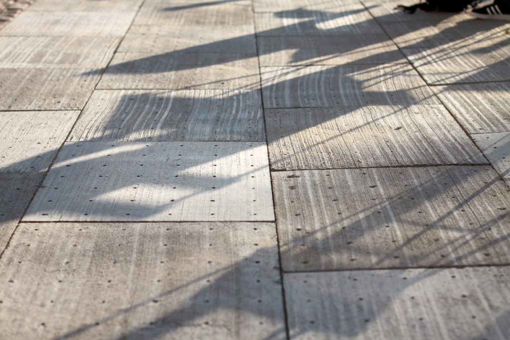 perforated paving slabs which act to drain excess water to surrounding plants.