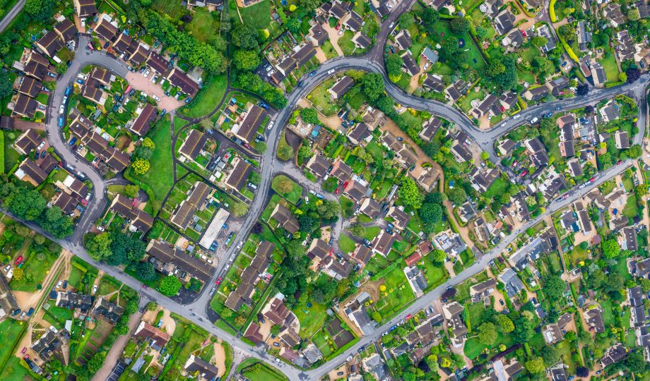 Aerial photograph of family homes suburban housing development green gardens Aerial photograph of family homes suburban housing development green gardens