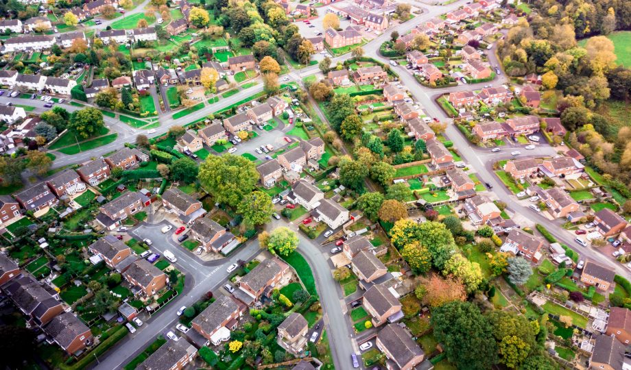 Aerial landscape view of homes on an English housing estate. Housing estate in the UK demonstrating old housing stock in need of retrofit