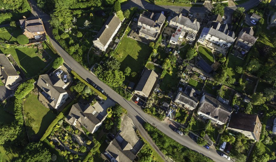 Aerial view over picturesque country homes green summer gardens Aerial view over picturesque country homes green summer gardens