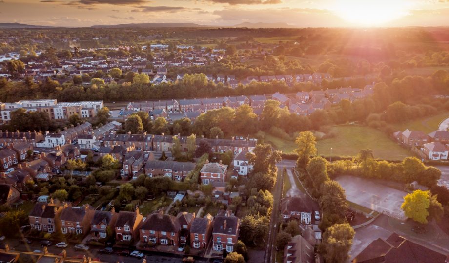 Sun setting with atmospheric effect over traditional British houses and tree lined streets. Sun setting with atmospheric effect over traditional British houses and tree lined streets.