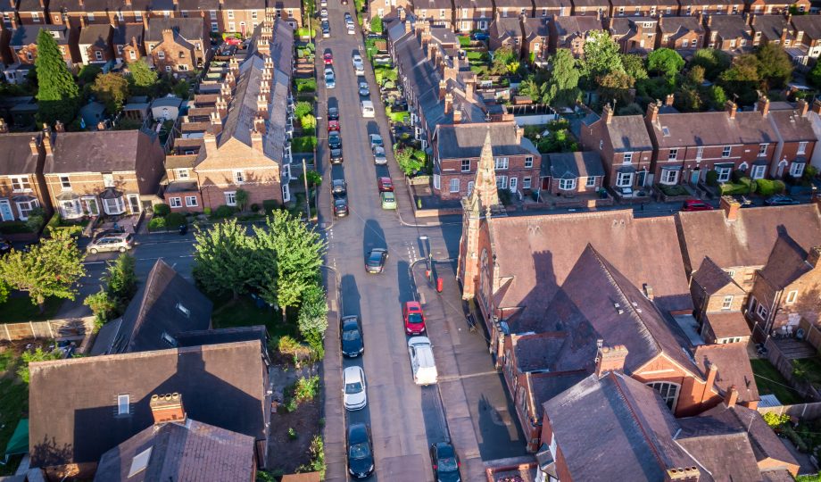 Sun setting with atmospheric effect over traditional British houses and tree lined streets. Sun setting with atmospheric effect over traditional British houses and tree lined streets.