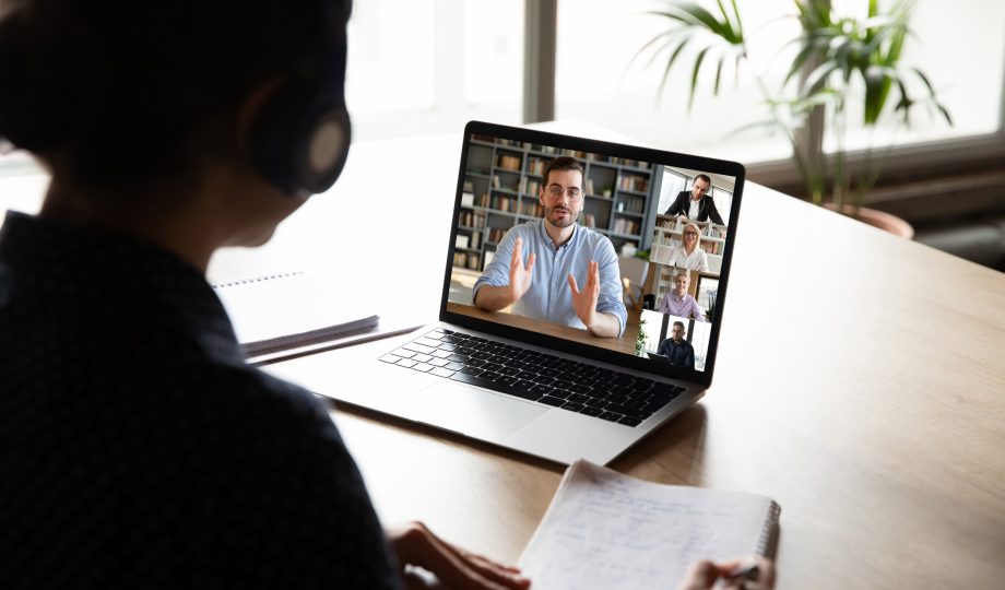 Pc screen view over woman shoulder during group videocall elearning Pc screen view over woman shoulder during group videocall elearning
