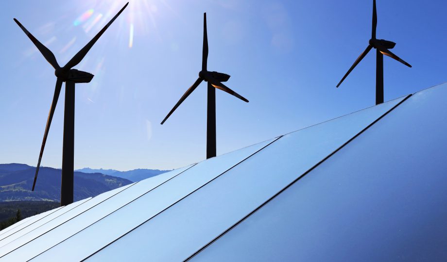 Solar park with wind turbines in the background Solar park with wind turbines in the background